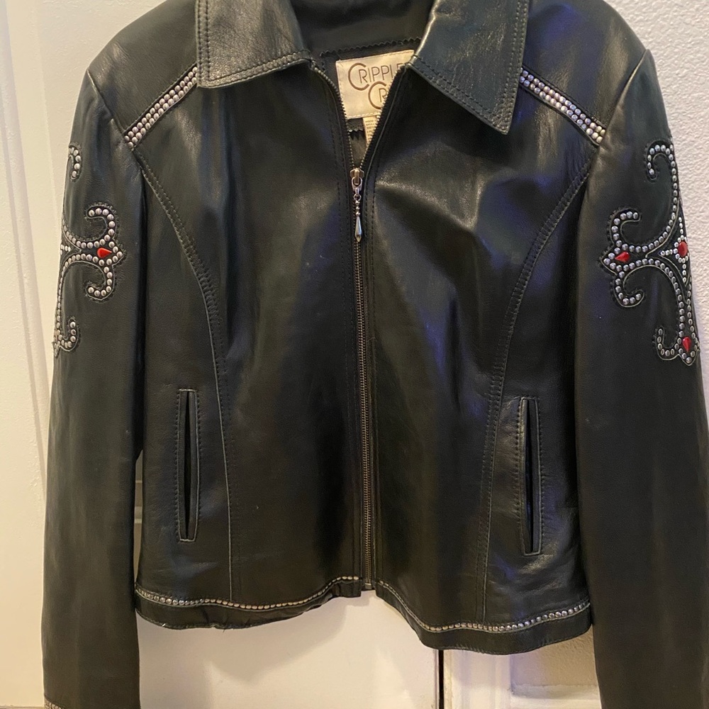 Black leather jacket silver and red studded trim.